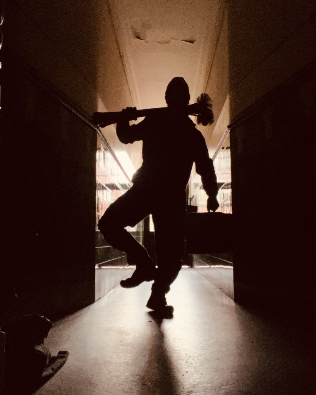 Professional chimney sweep serving Stirling and Central Scotland Silhouette of a chimney sweep carrying a brush through a doorway