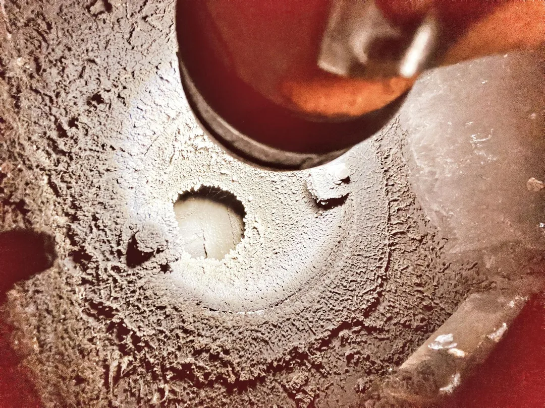 Creosote and tar buildup inside a chimney Heavy creosote and glazed tar buildup inside a chimney flue
